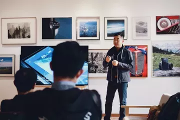 man presenting photos